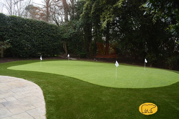 Naperville Synthetic grass golf green with 4 holes and flags in a landscaped backyard