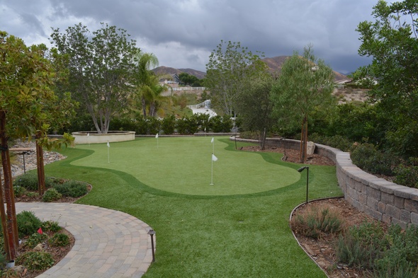 Naperville Synthetic grass golf green in a landscaped backyard