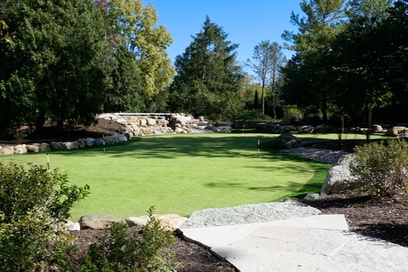 Naperville lush green synthetic grass golf course with white sand bunkers and blue sky