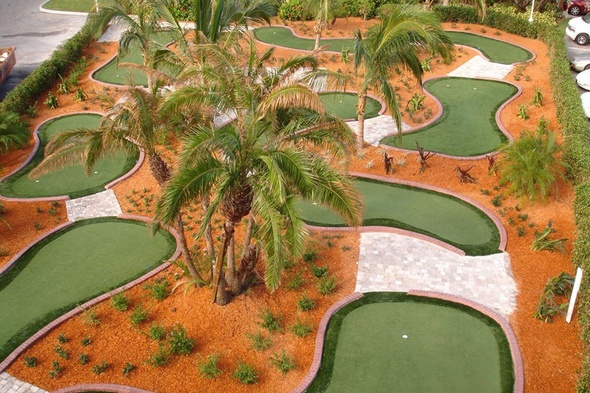 Naperville Aerial view of a mini golf course with synthetic grass and palm trees.